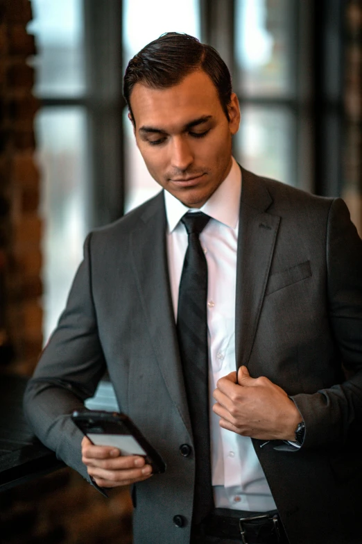 a man looking down at his cell phone