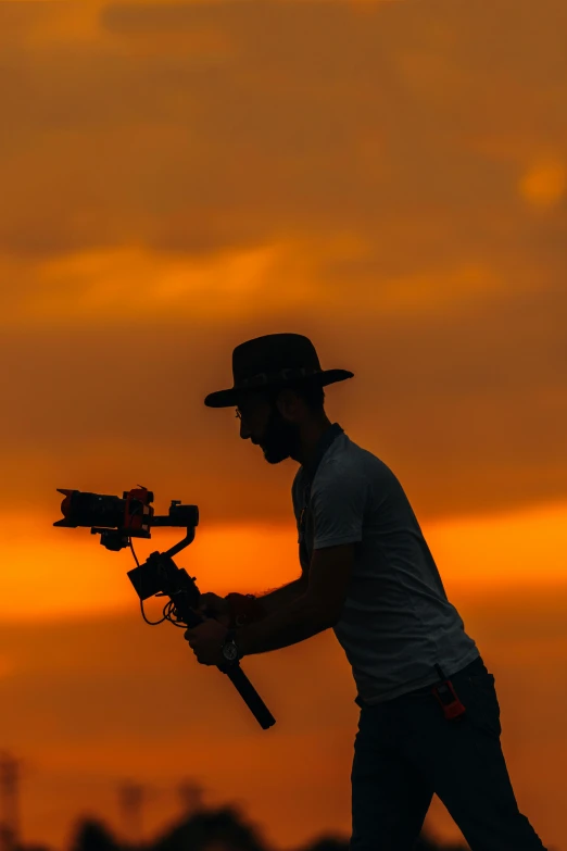 a man is holding two remote controls to the camera