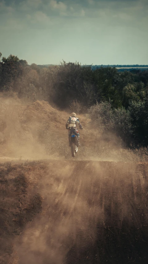 person on motorbike turning in the sand