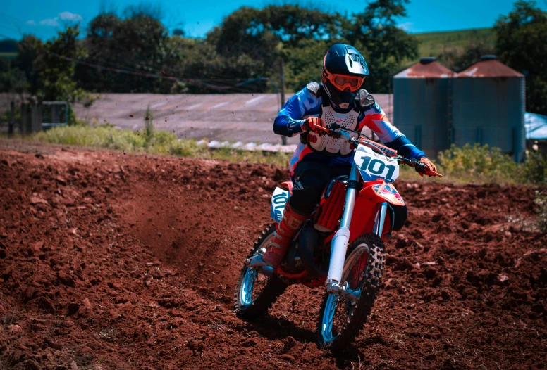 a person riding a dirt bike on a red track