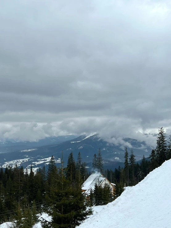 a person is standing on a snow covered mountain with skis