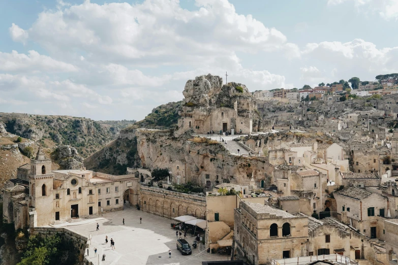 a village has a very steep cliff with buildings and towers