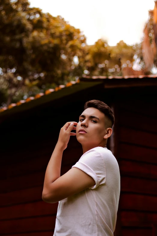 a young man holding a cell phone to his ear