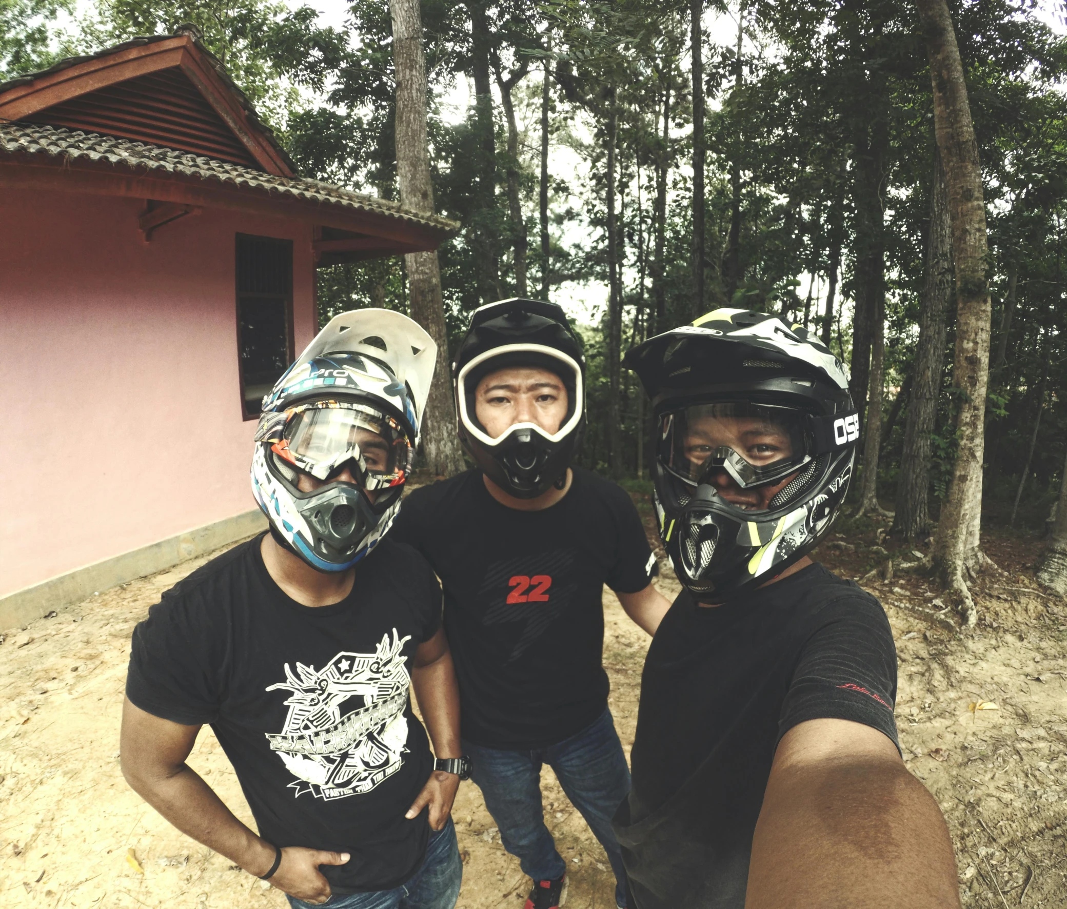 three people wearing protective helmets, taking a picture