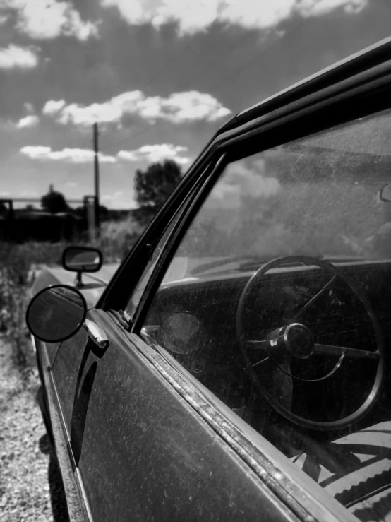 an old truck parked on the side of a road