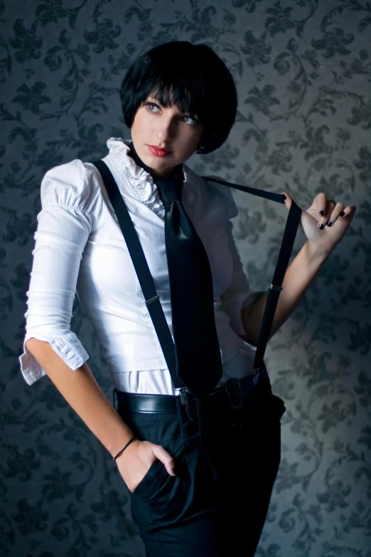 woman in white shirt and black pants holding black tie and suspenders