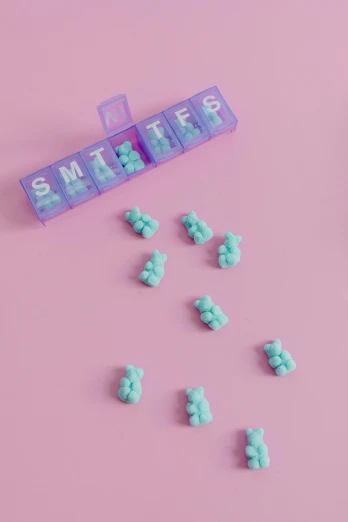 tiny toys on pink surface with word