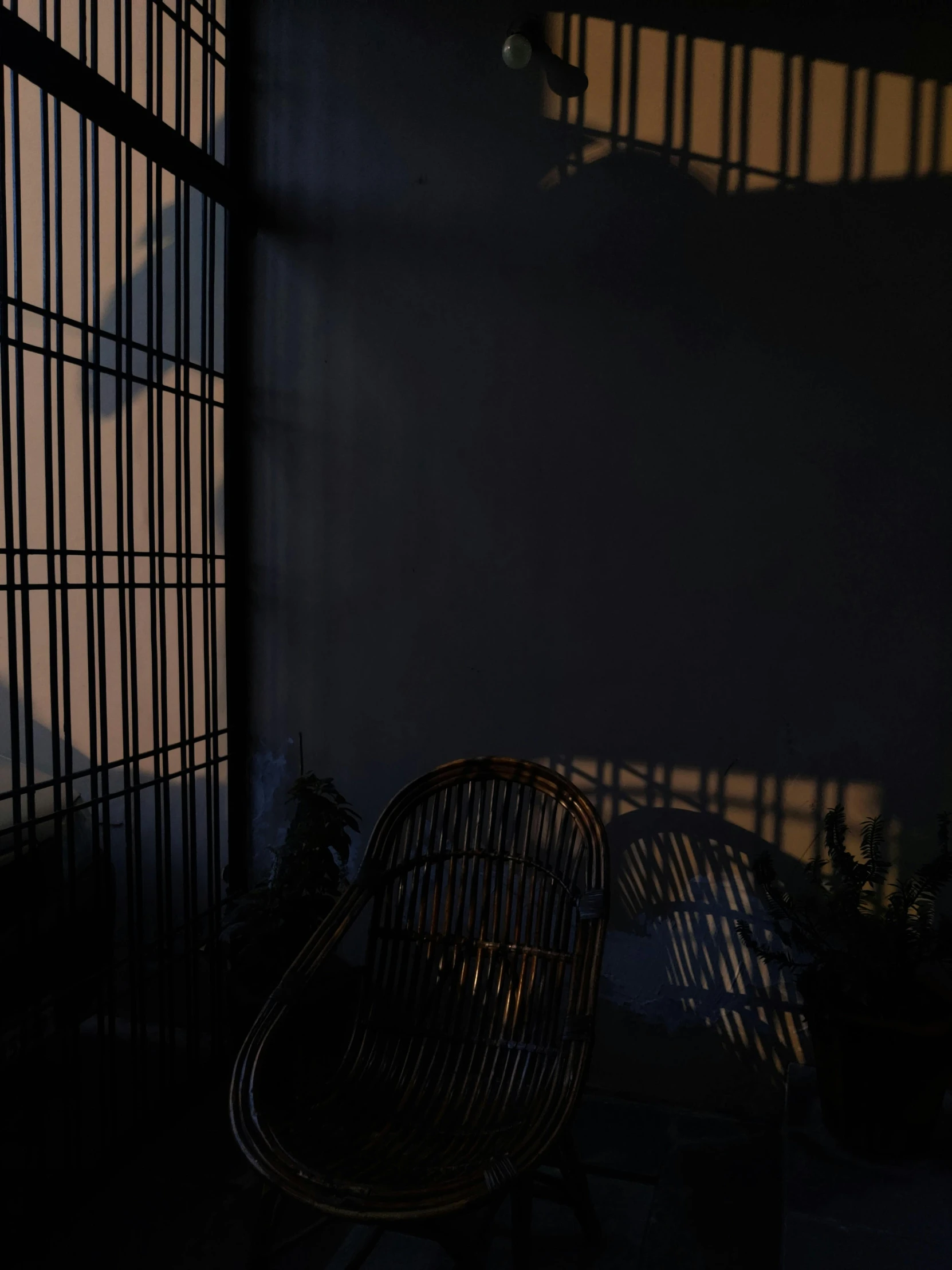 an empty living room area with shadows on the wall