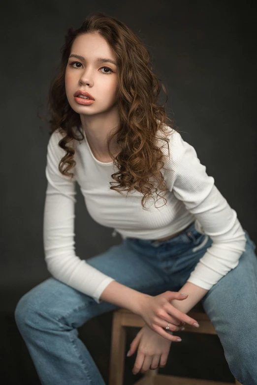 a young woman with dark hair is posing