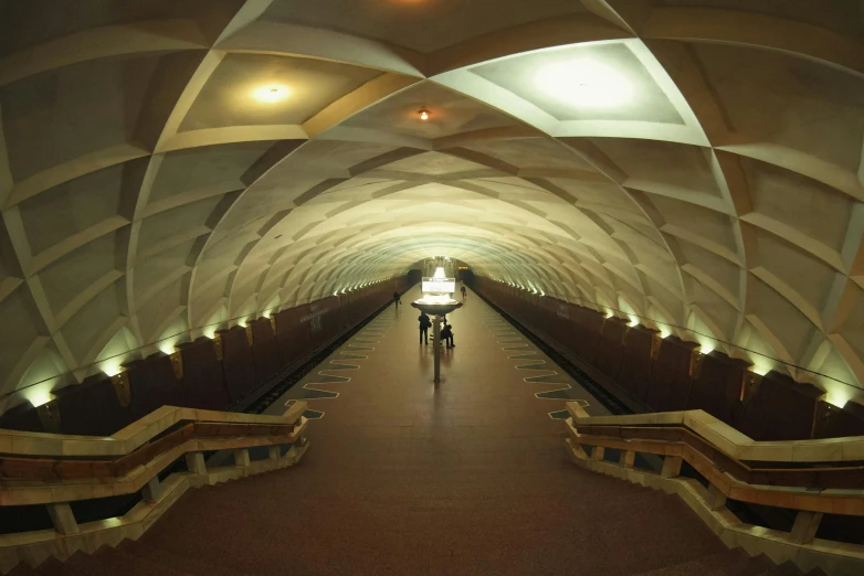 two cyclists riding through a tunnel in a subway