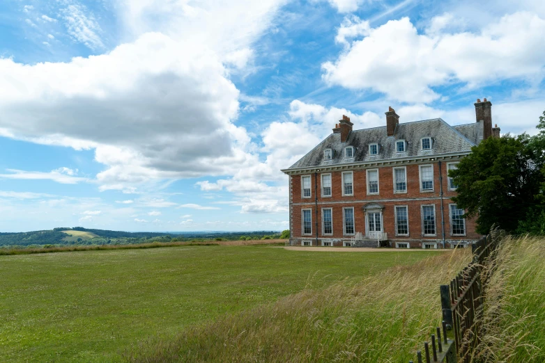 there is a large brick house in the field