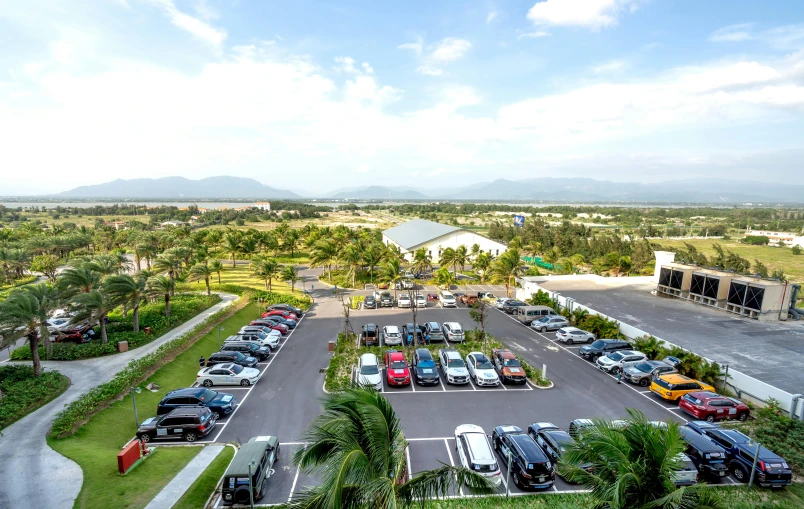 a parking lot filled with lots of different parked vehicles