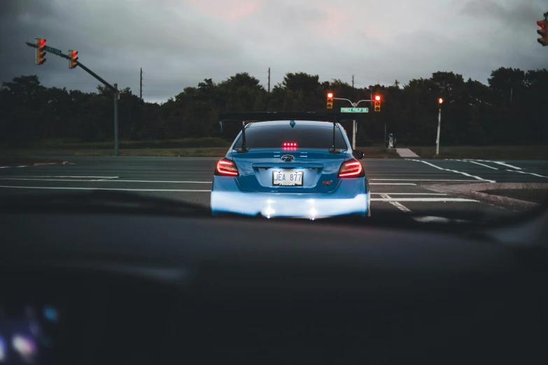 the front end of a car that has light up tail lights on