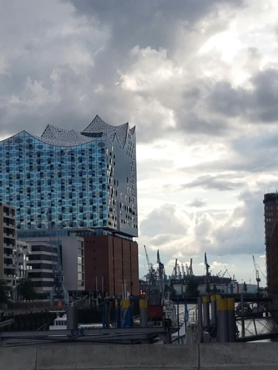 a large building and boats in the harbor