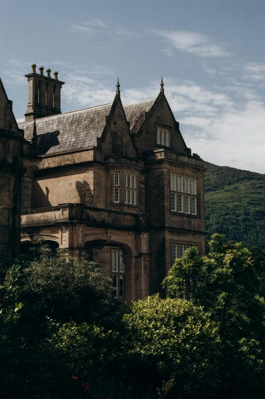 an old mansion with several chimneys on top