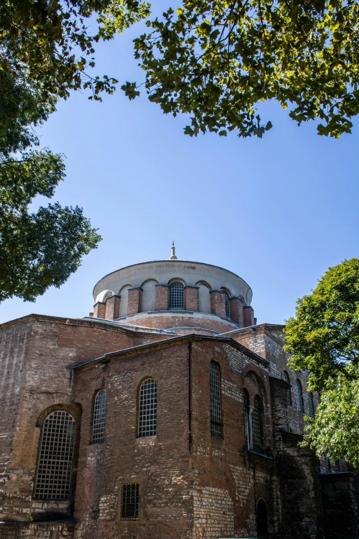 an old brick building with arched windows and a dome