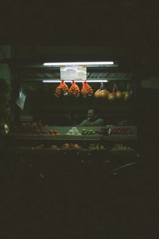 a food market in the dark showing meat and vegetables