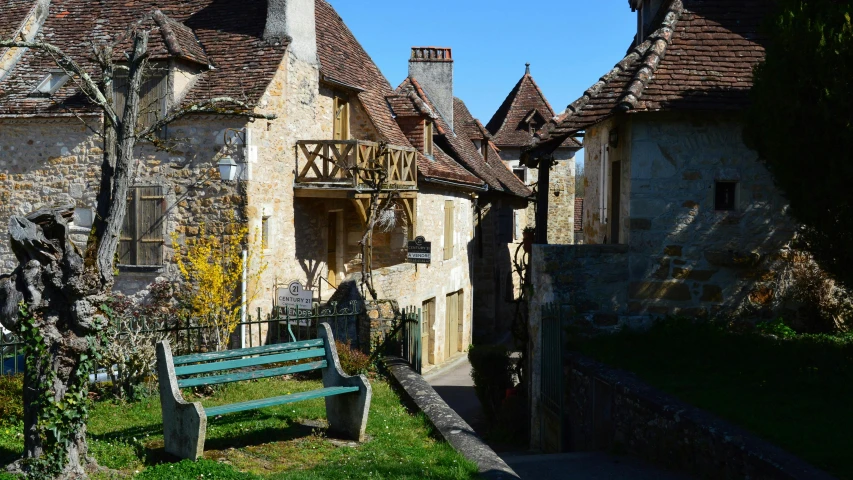 a bench in front of an old castle like building