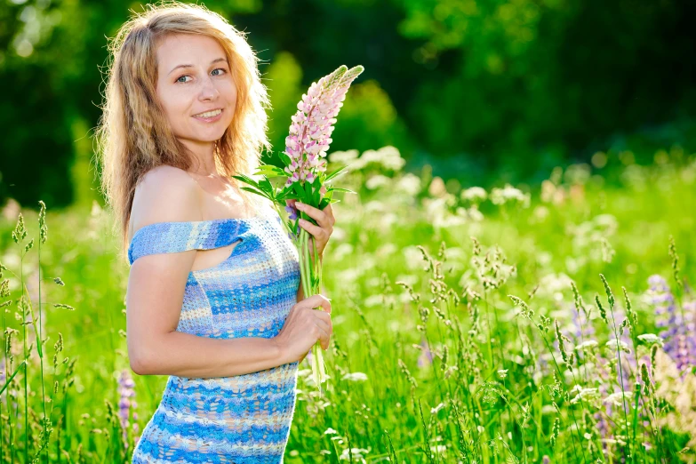 a young lady is posing for the camera in the middle of the grass