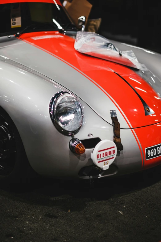 the front of an orange and grey vintage sports car