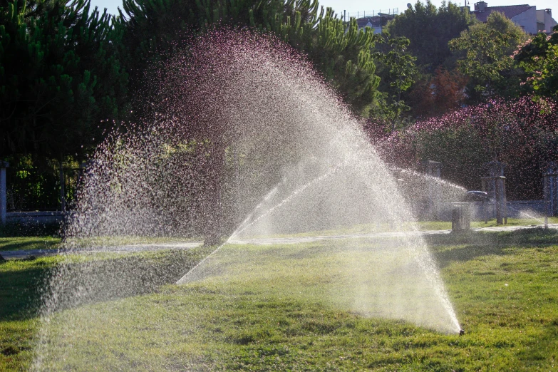 a fire hydrant spewing water with it's mouth open