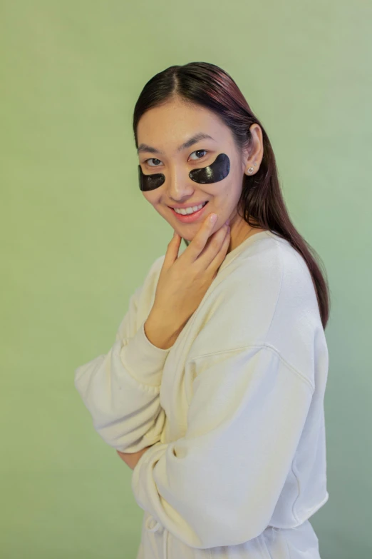 a woman posing with a fake pair of black eye lashes