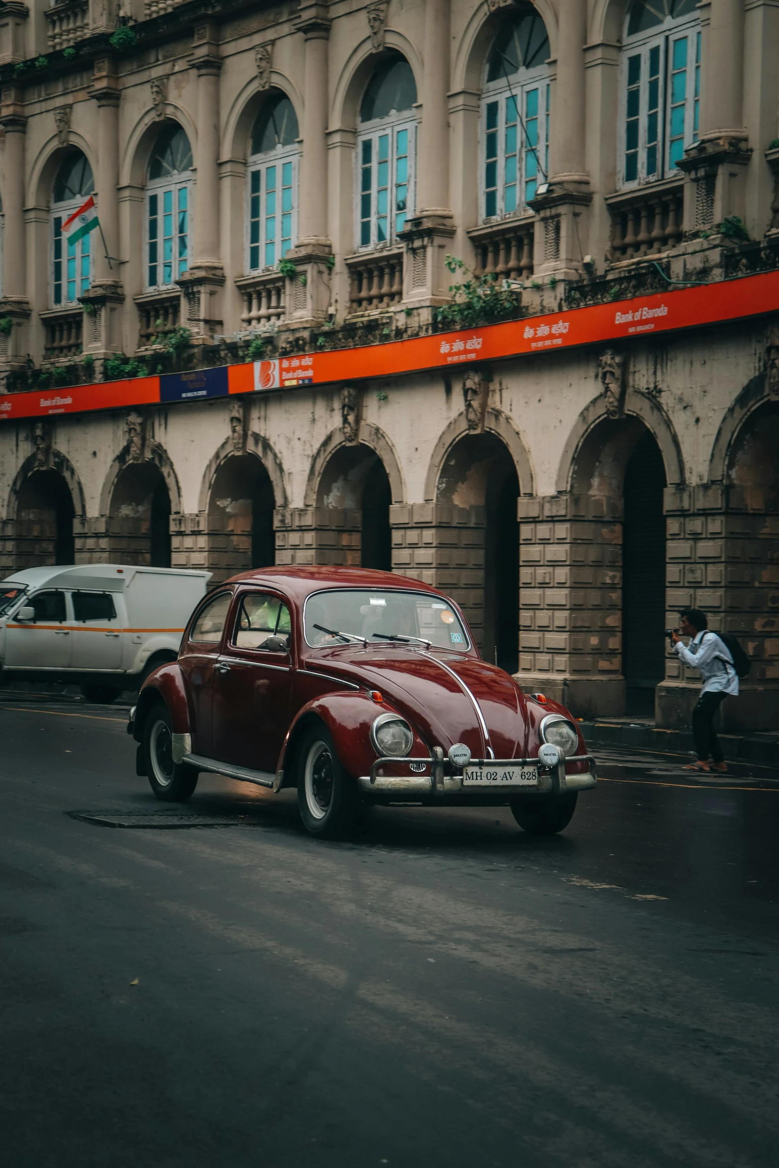 a classic car sitting in the middle of a city street