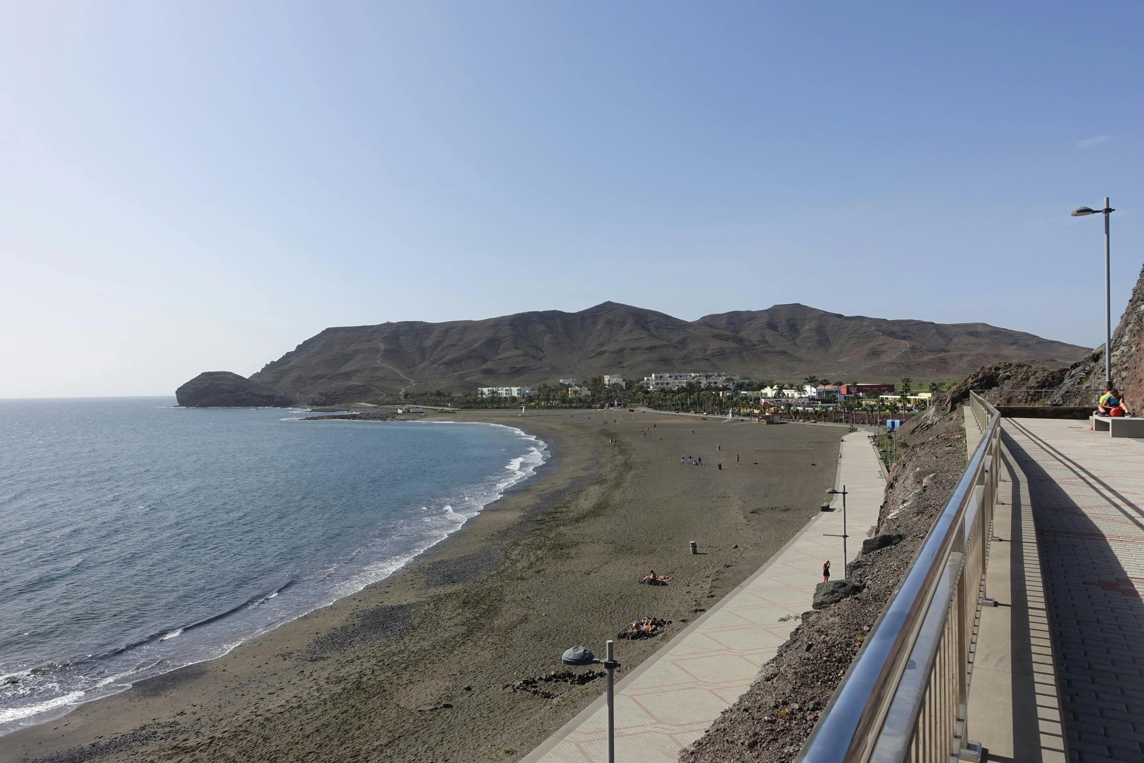 a view from a distance looking out at the water and sand