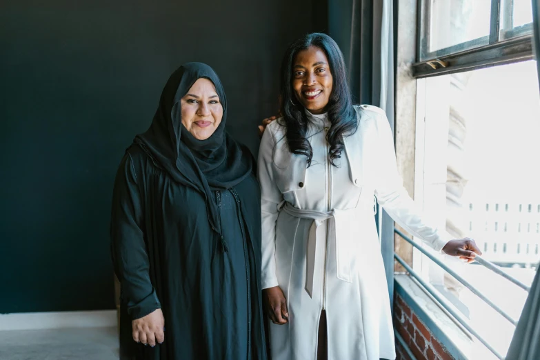 two beautiful women standing next to each other