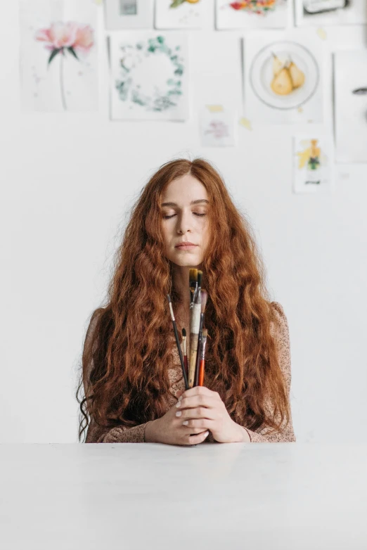 the girl is holding a whisk while staring