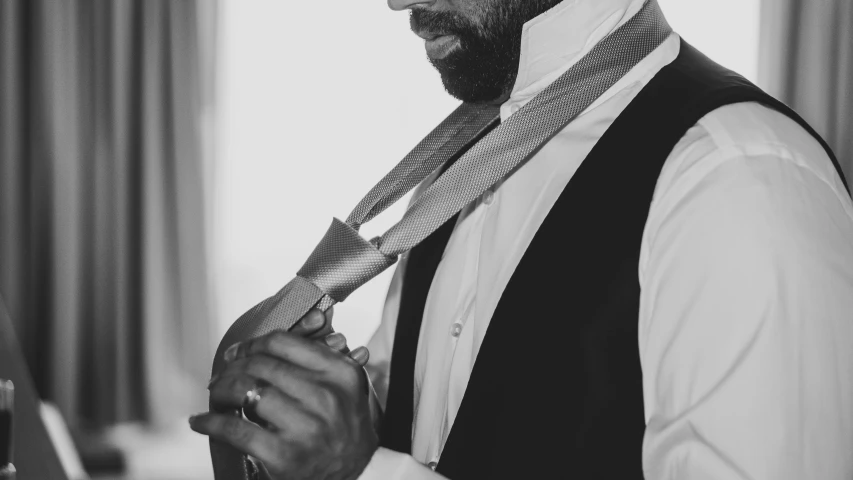 a man wearing a tie and jacket with a beard