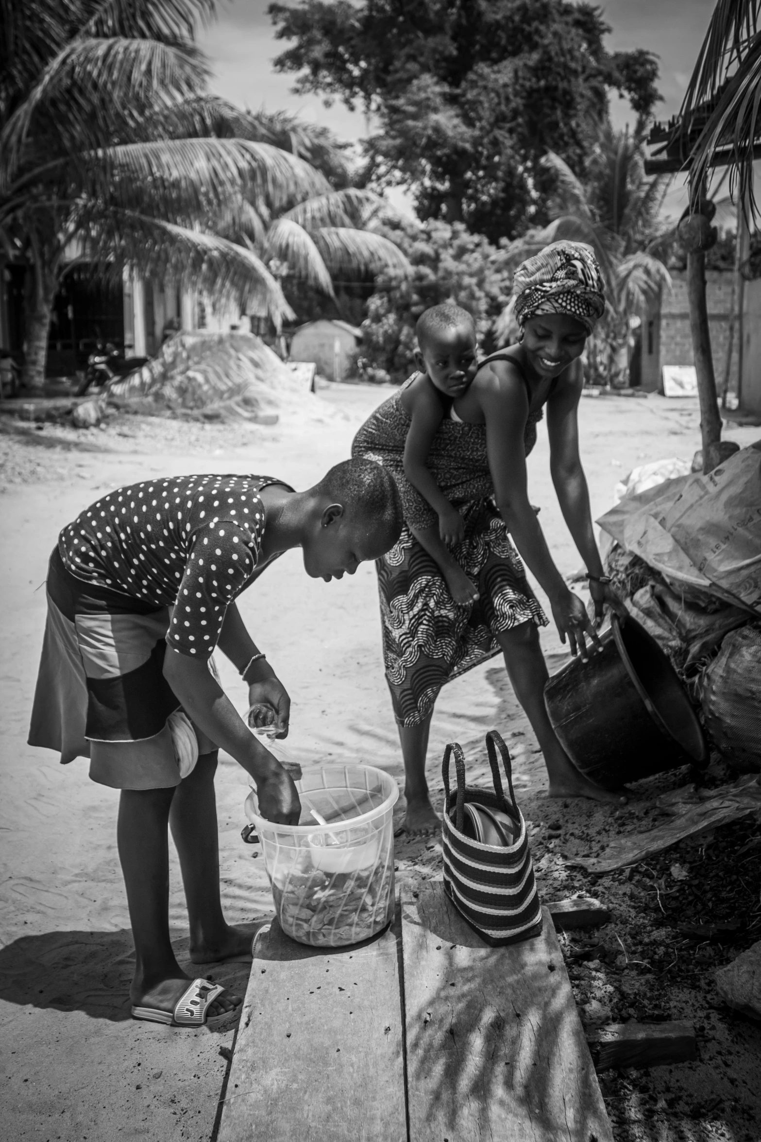 women are washing up water on the beach