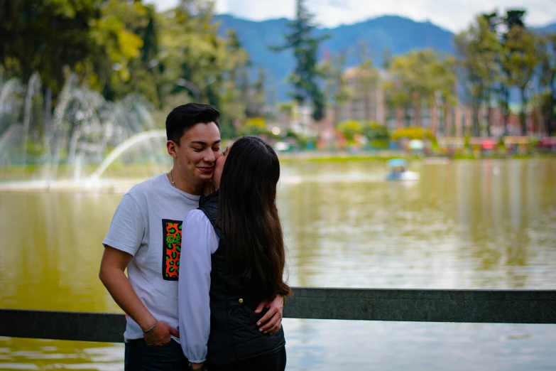 the young man is giving the woman some kisses