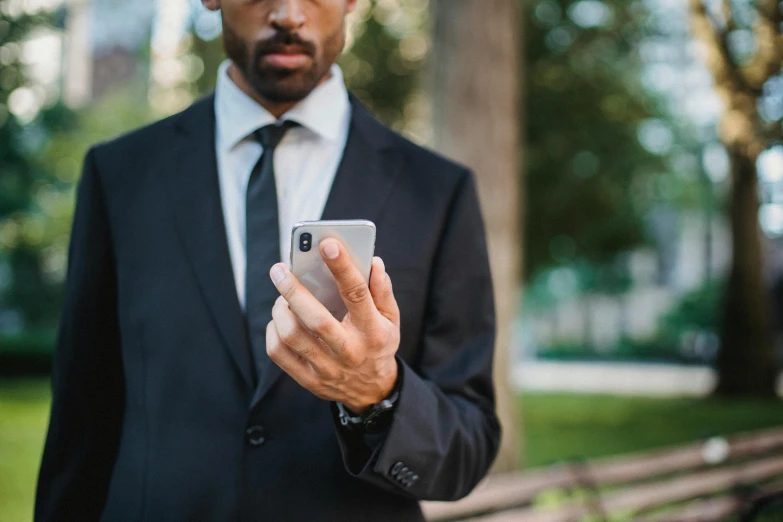 a man wearing glasses looking at his cellphone