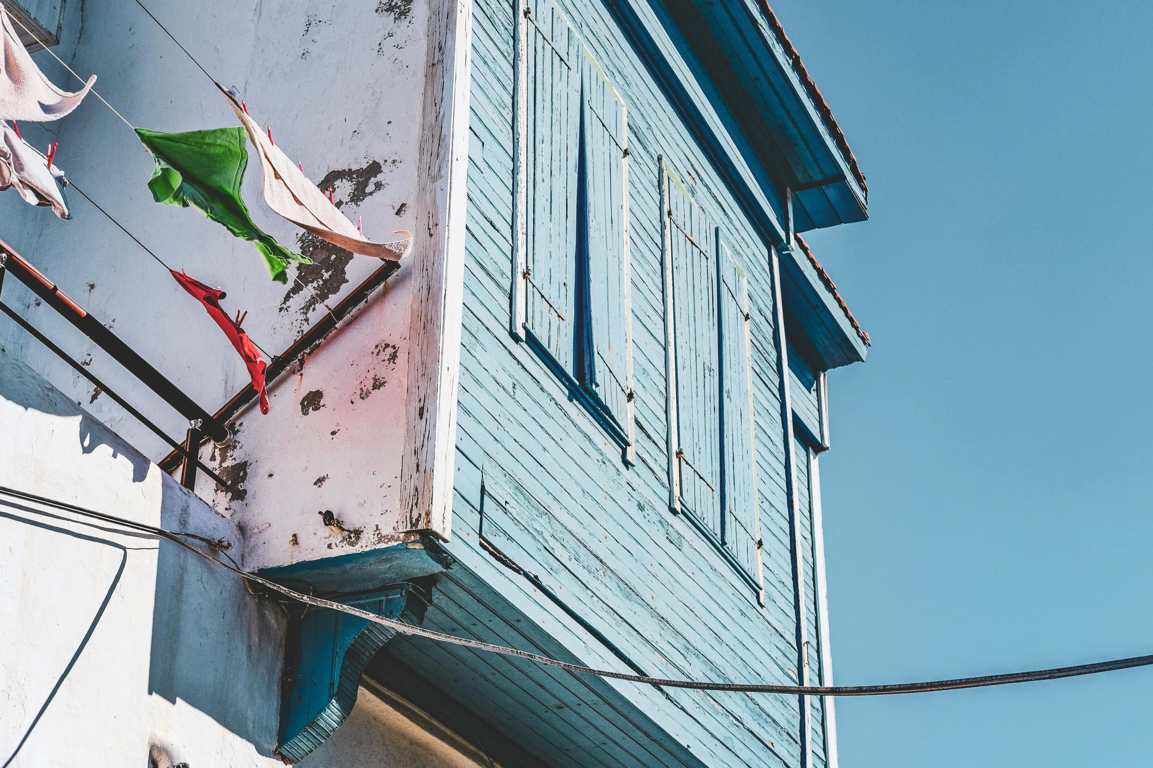 a blue building with some clothes hanging off it