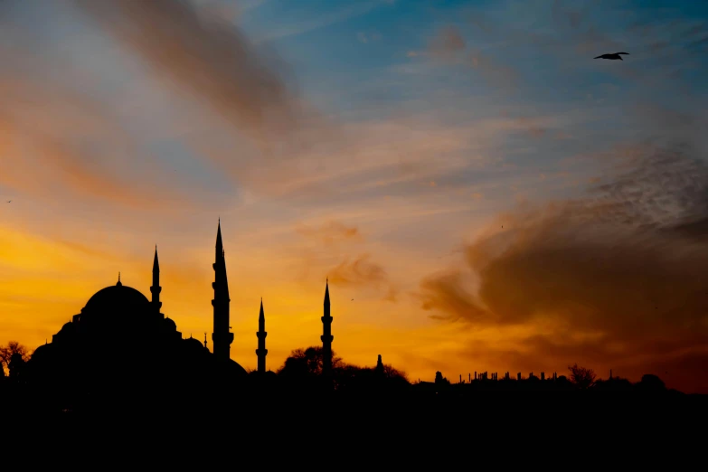 sunset s of two old minarets on a hill