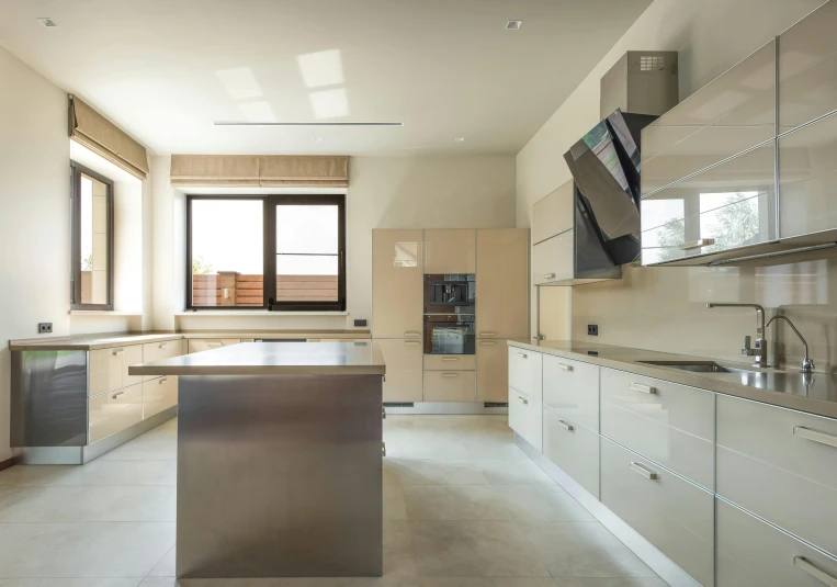 an open plan kitchen with beige cabinets and stainless steel counter tops