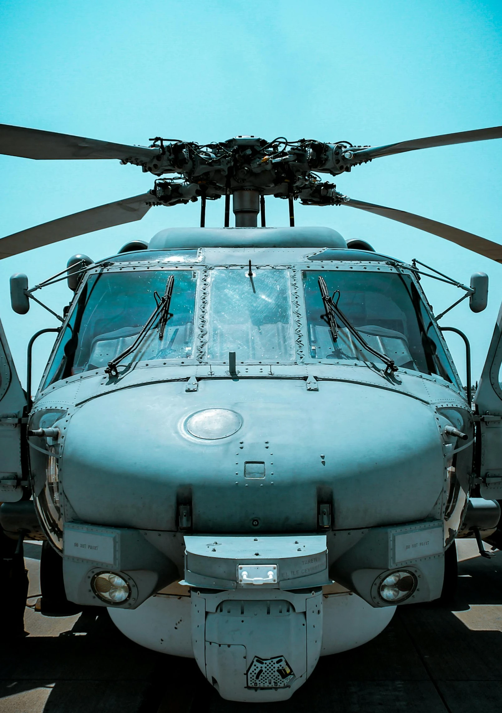 a helicopter with two propellers parked on the tarmac