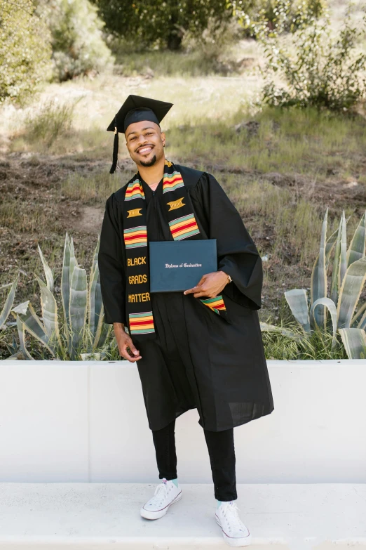 a person that is wearing some kind of graduation gown