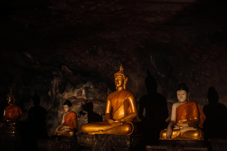 buddha statues are lined up inside a cave