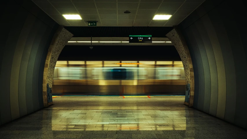 a subway station with only one person walking