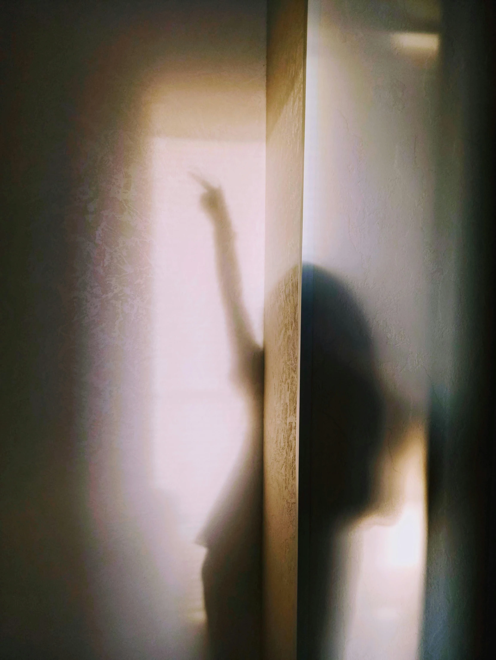 a person with their arm extended in front of a wall