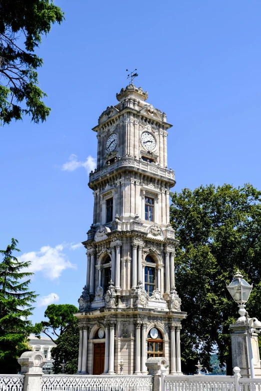 there is a tower with a clock displayed against the sky