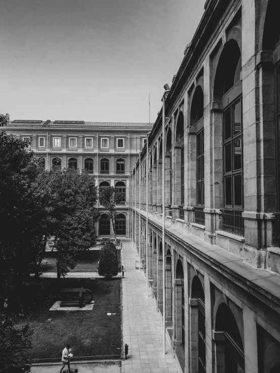 view of buildings with one person sitting on a bench looking at the scenery