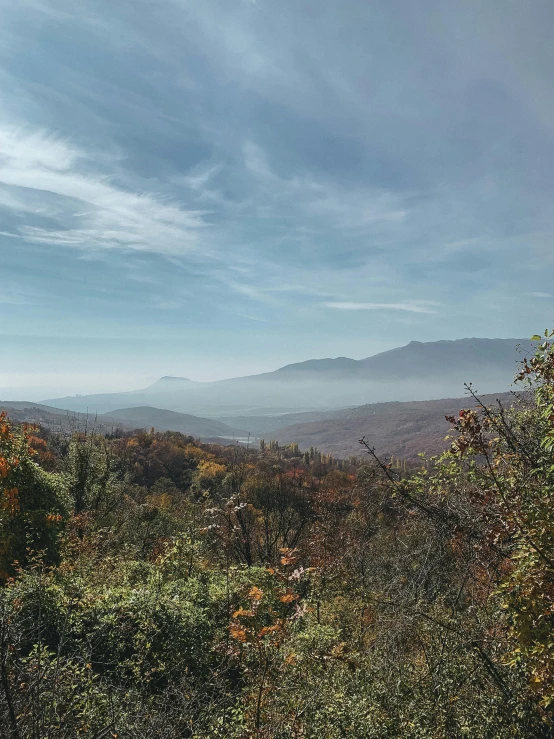 view from the top of a mountain with fog rolling in the distance