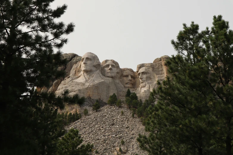 a large mountain with many faces on it