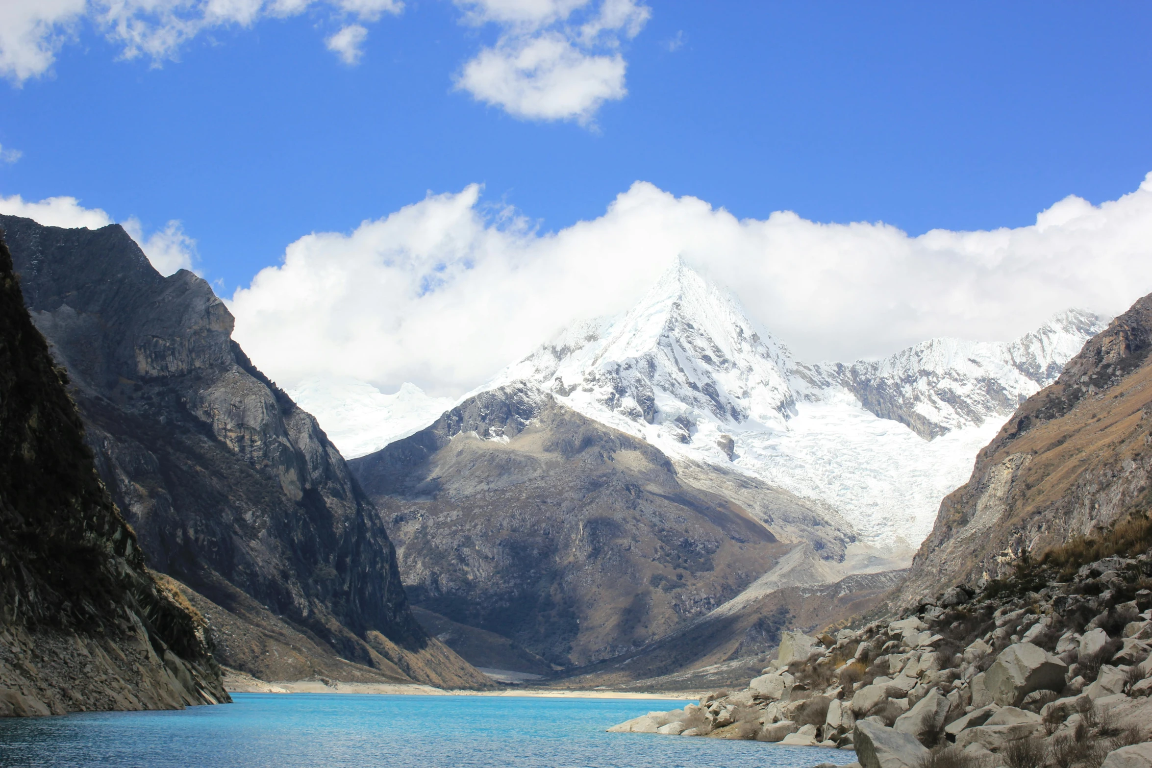 mountain view of a lake with rocks and boulders near by