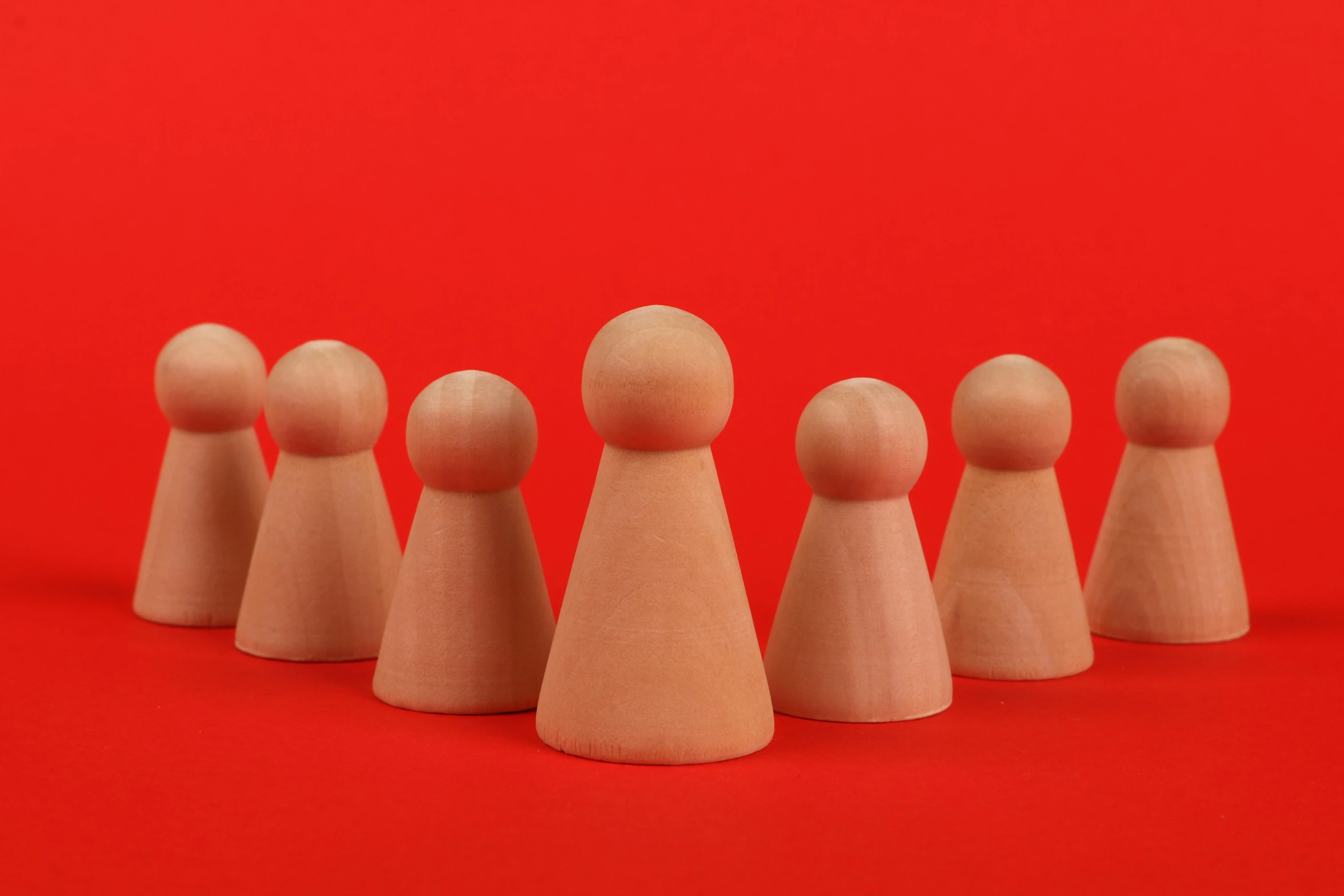 a group of wooden dolls in a row