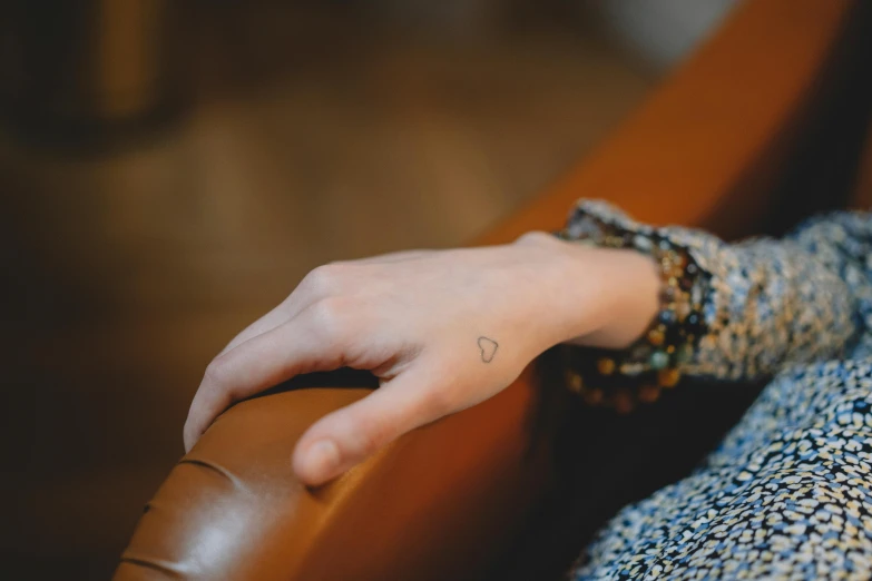 a woman with a small star tattoo on her hand