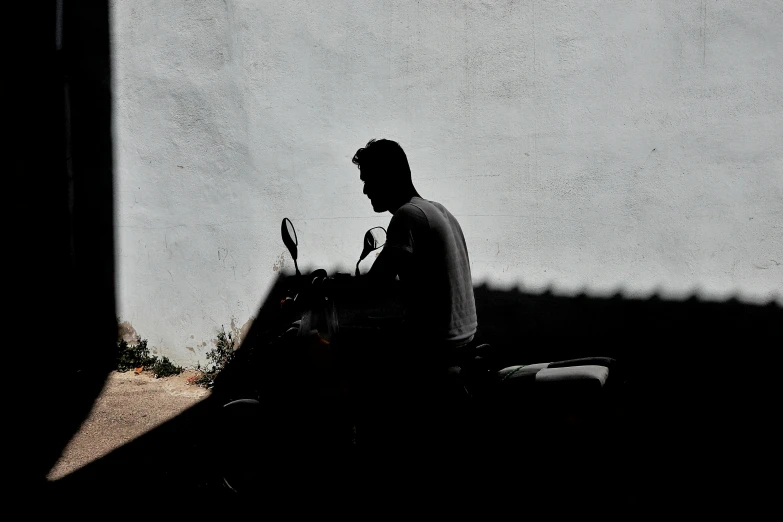 a person on a motor cycle driving by in the dark